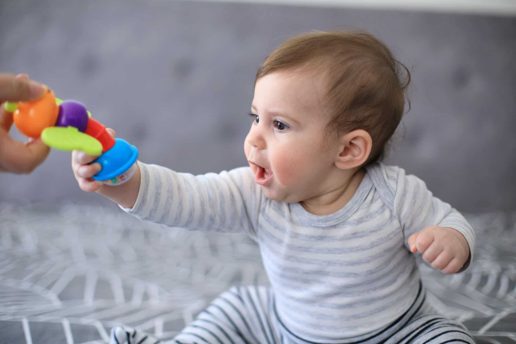 Infant improving hand-eye coordination through play